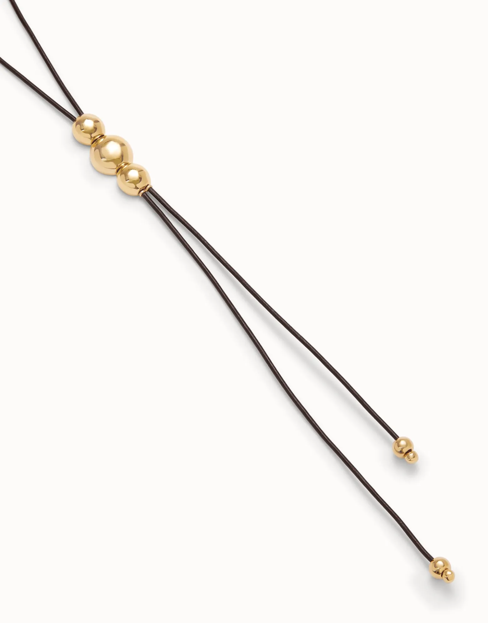 Colgante de cuero largo con tres bolas centrales bañadas en oro de 18K