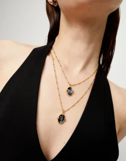 Collar doble bañado en oro 18k con dos cristales facetados ovalados negros