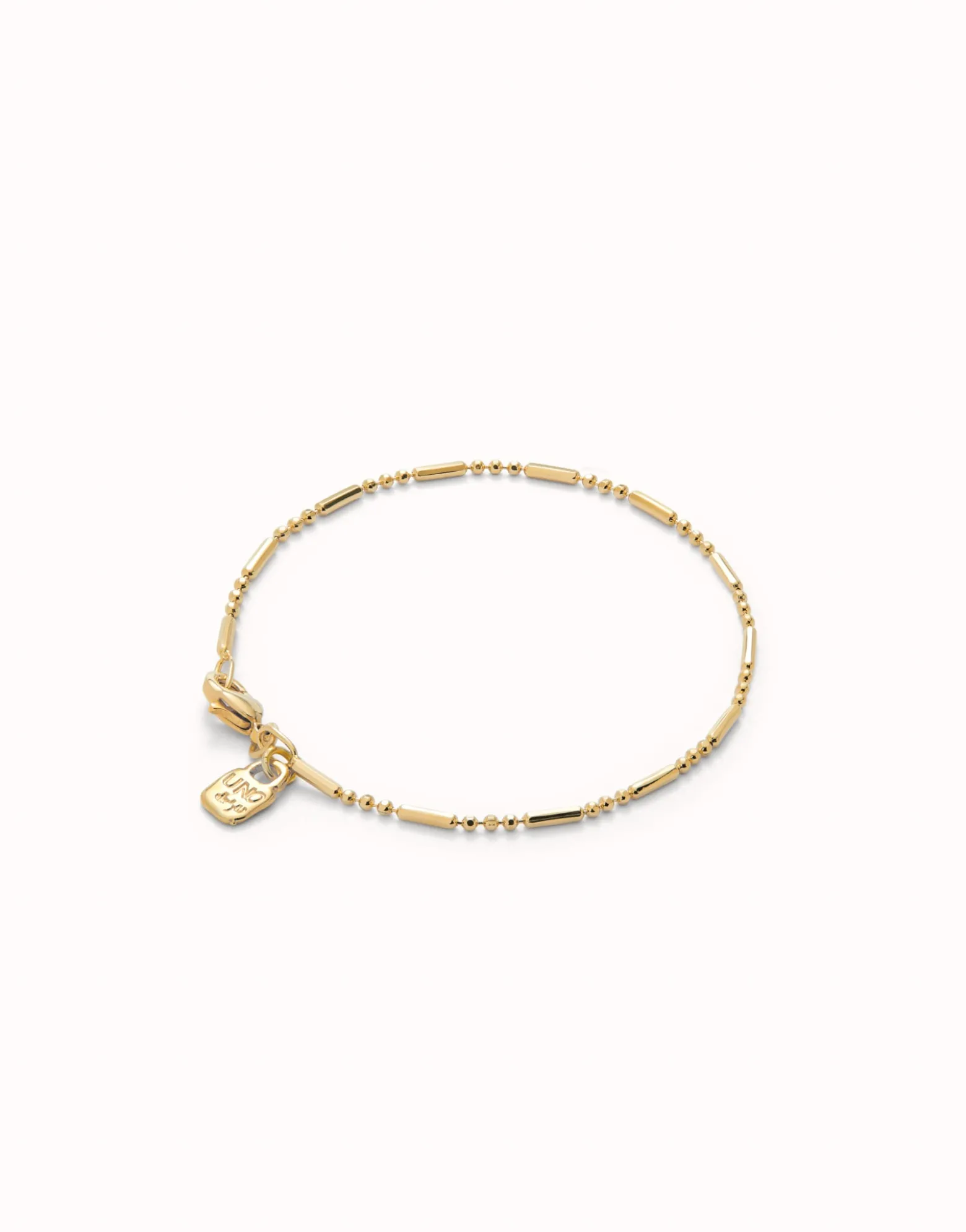 Pulsera con bolas y piezas alargadas bañada en oro 18k