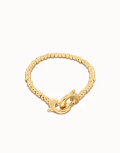 Pulsera de bolas pequeñas bañada en oro con mosquetón entrelazado