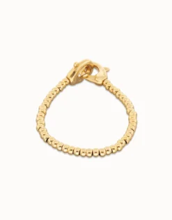 Pulsera de bolas pequeñas bañada en oro con mosquetón entrelazado