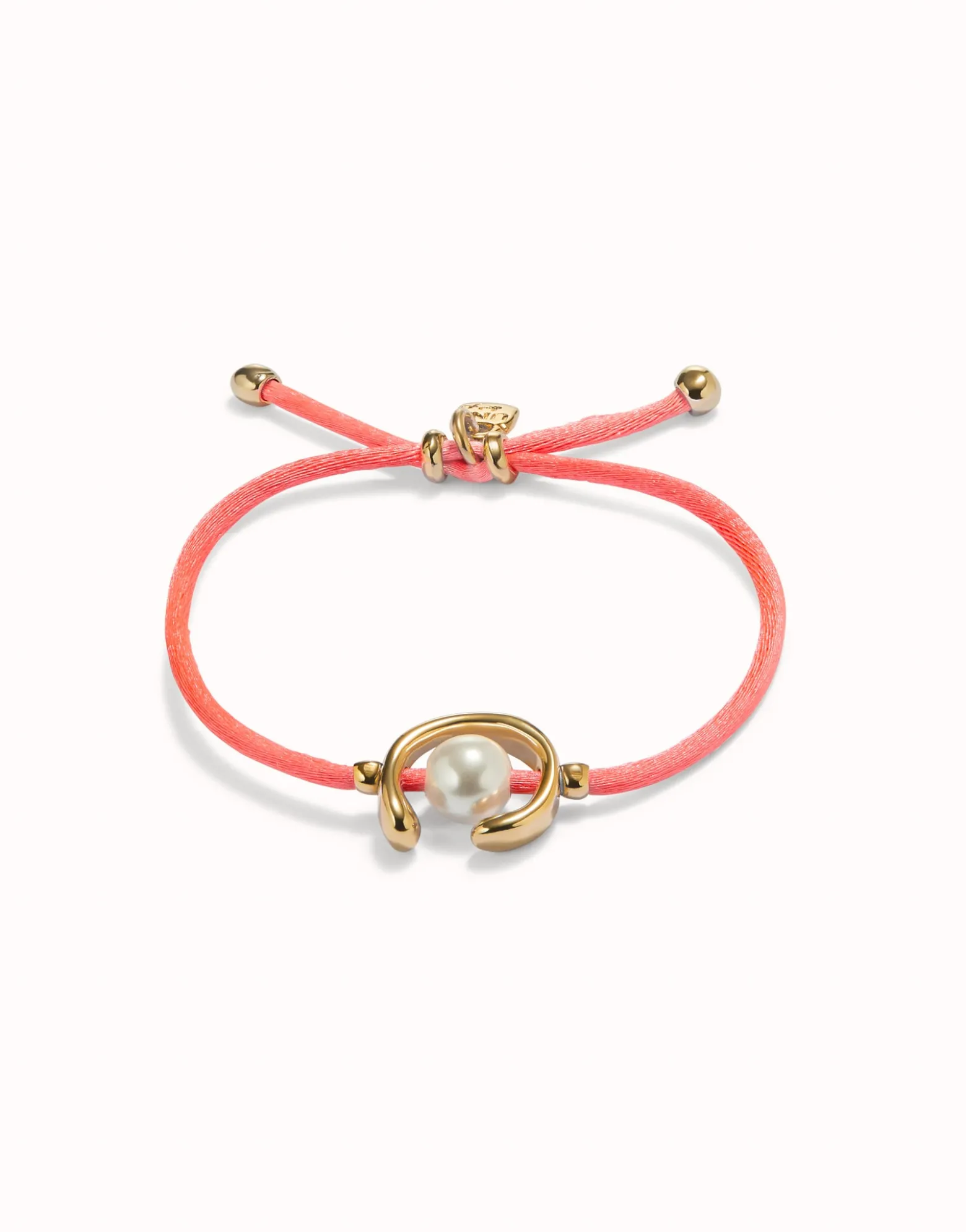 Pulsera de hilo fucsia con perla shell fornitura bañada en oro 18k.