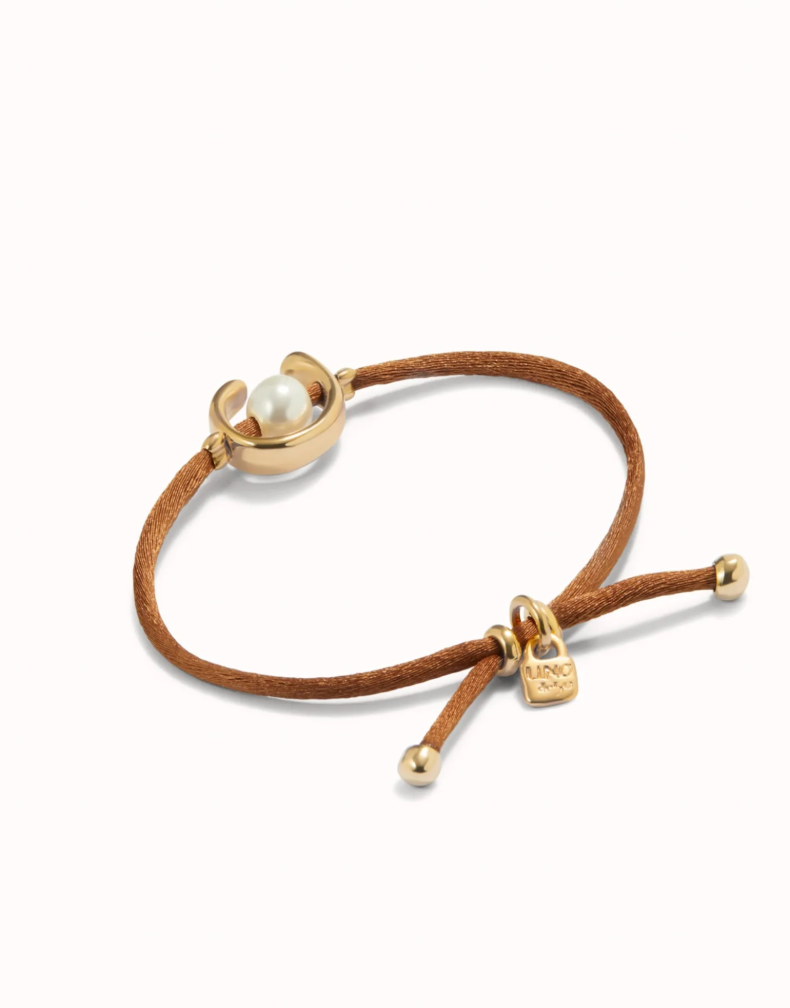 Pulsera de hilo marrón con perla shell fornitura bañada en oro 18k.