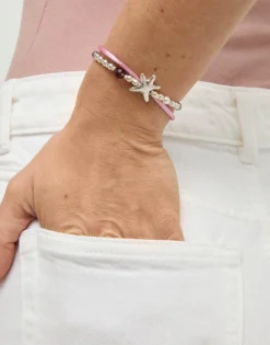 Pulsera de hilo seda color rosa bañada en plata con estrella de mar