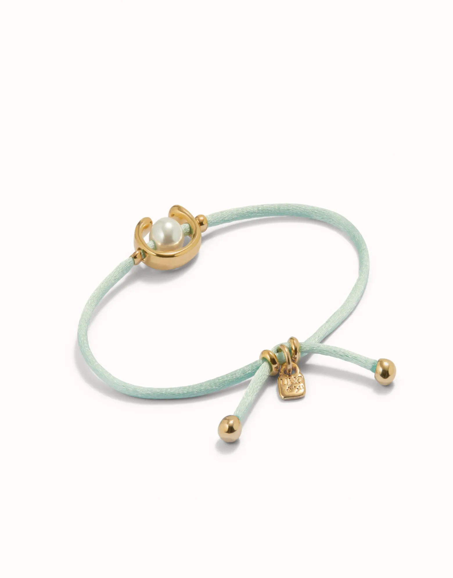 Pulsera de hilo verde azulado con perla shell fornitura bañada en oro 18k.