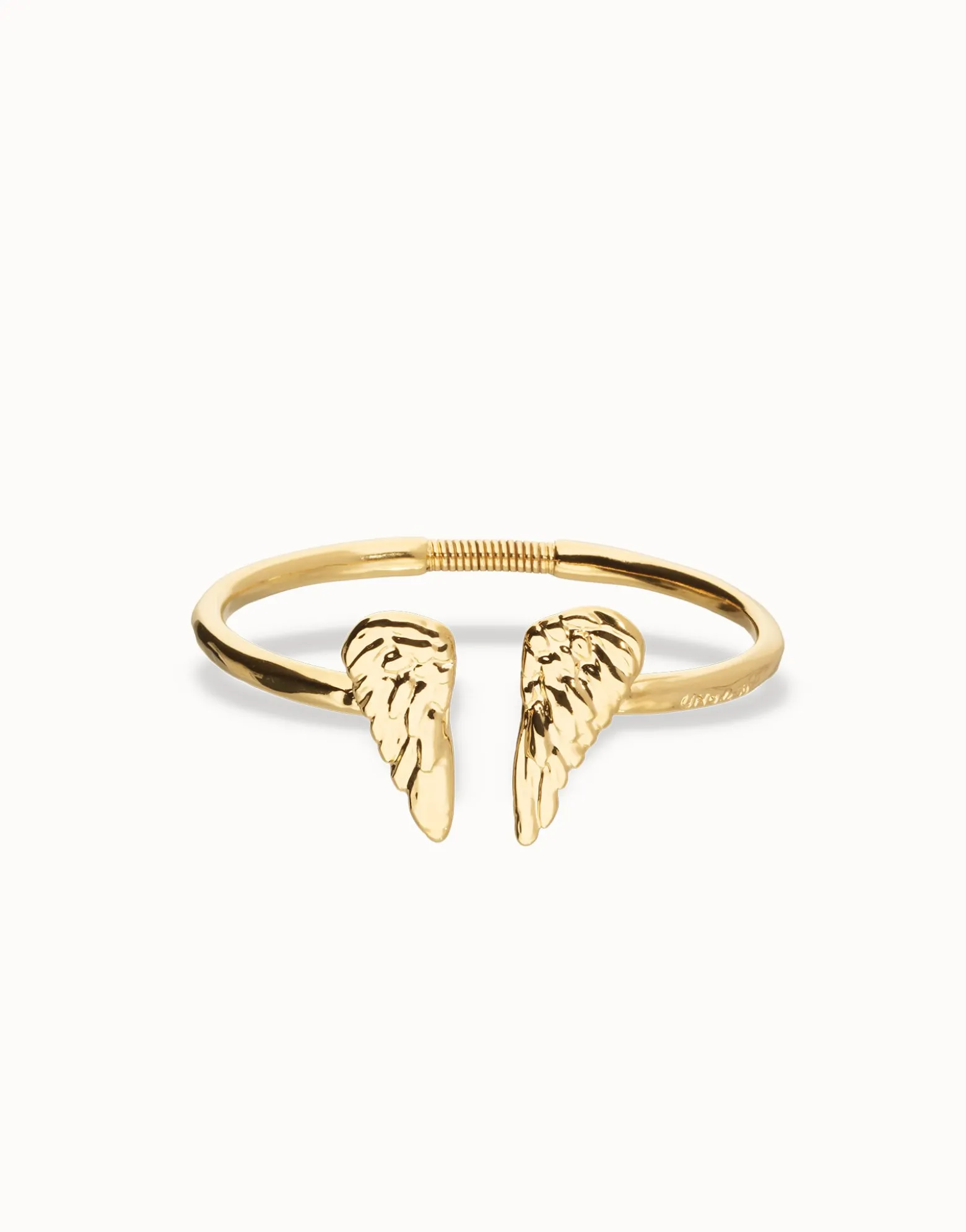 Pulsera rígida bañada en oro 18k con detalle de alas