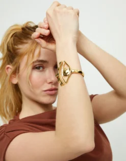 Pulsera rígida bañada en oro 18k con detalle de ojo