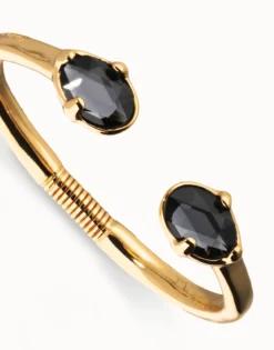 Pulsera rígida bañada en oro 18k con dos cristales facetados ovalados negros
