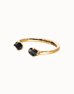 Pulsera rígida bañada en oro 18k con dos cristales facetados ovalados negros